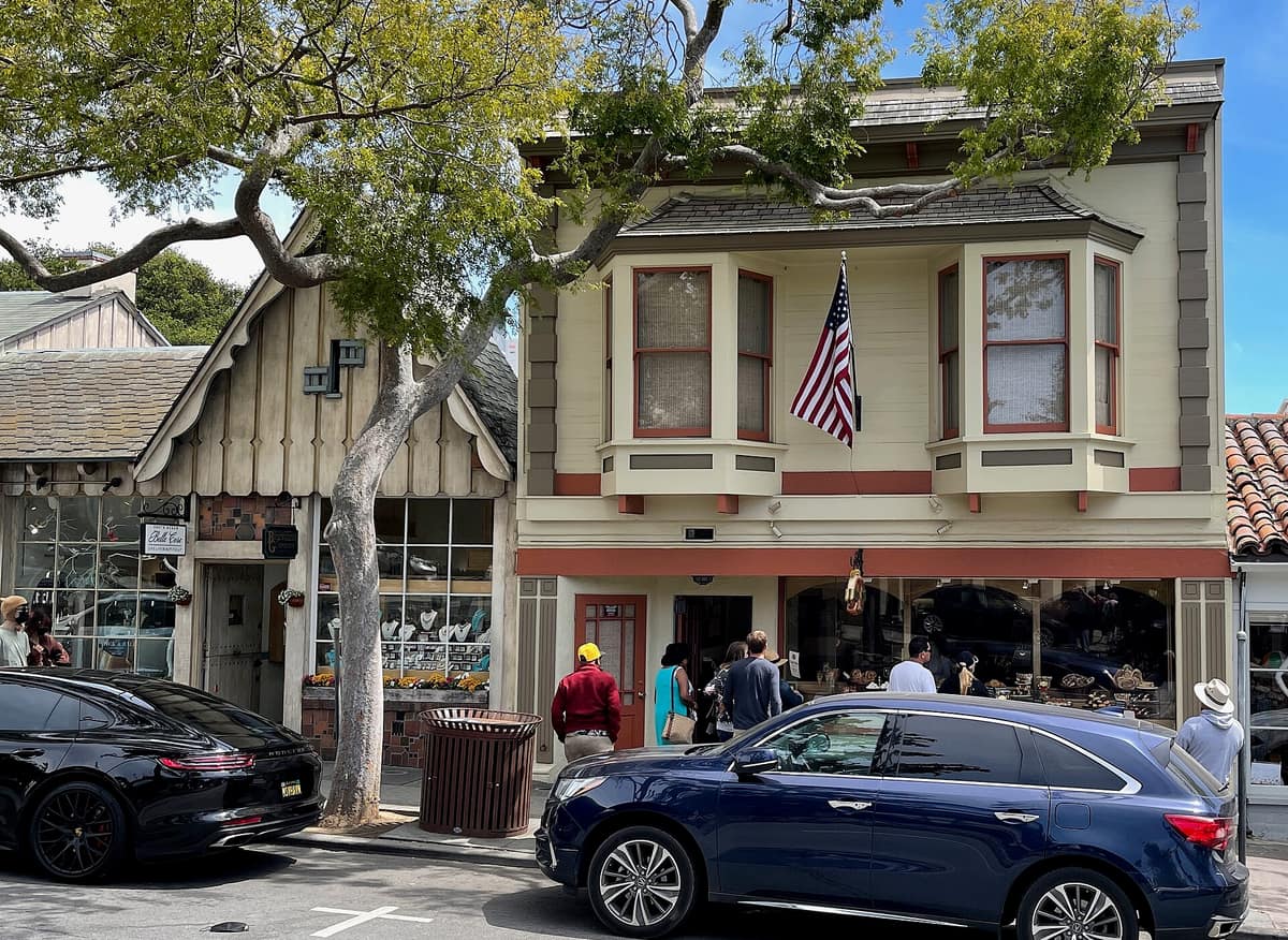 The Carmel Bakery building on Ocean Avenue, beside a storybook-style shopfront
