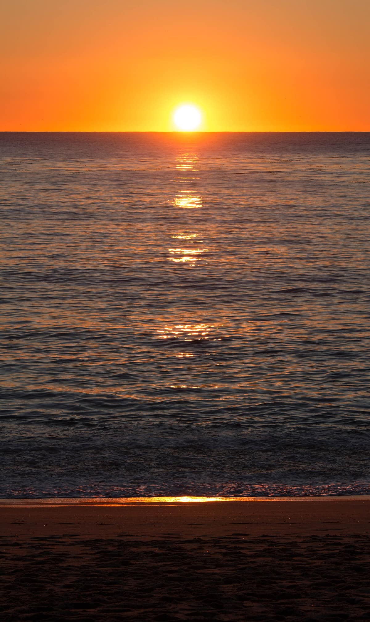 The sun setting over the Pacific at Carmel River State Beach