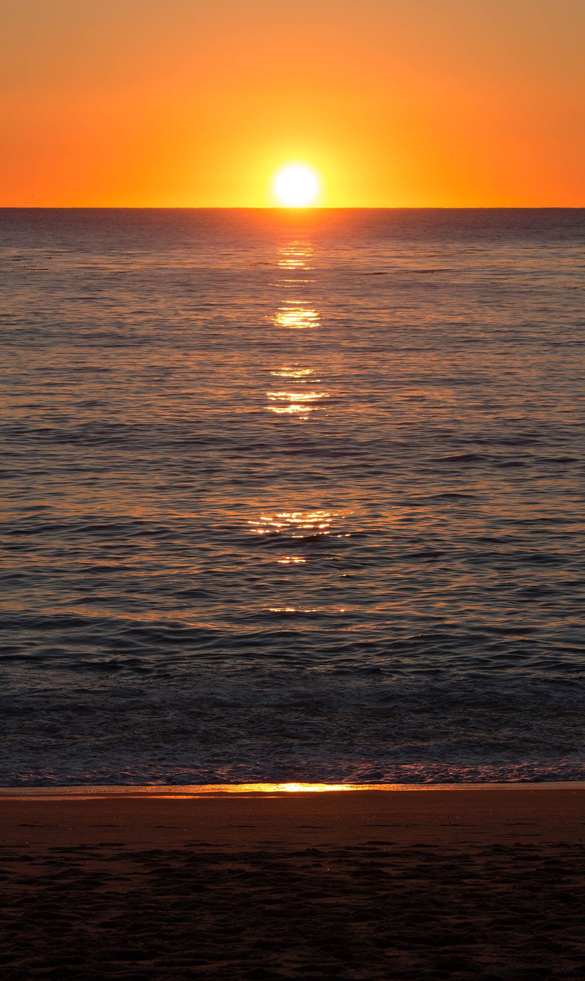 The sun setting over the Pacific at Carmel River State Beach